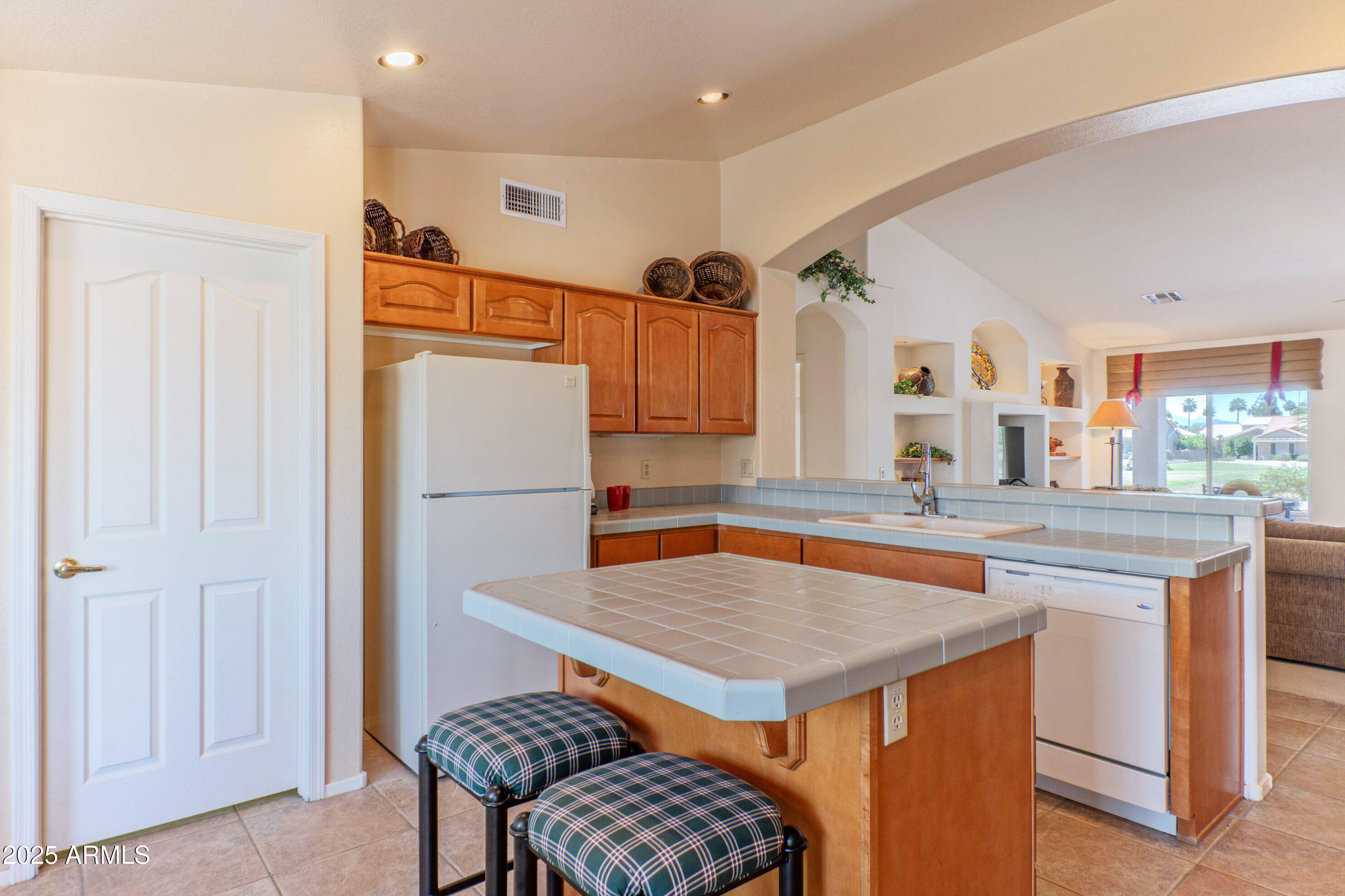 15371 Piccadilly Road Goodyear, AZ 85395 - Photo 10 of 26 a kitchen with a table chairs refrigerator and stove