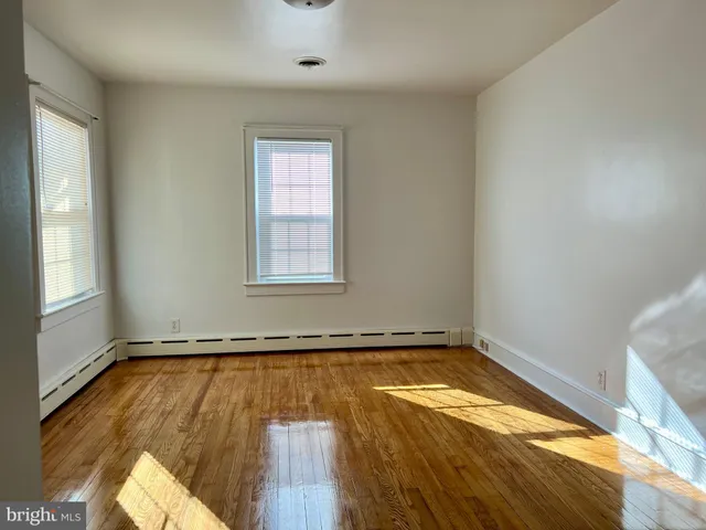 a view of a room with wooden floor and window