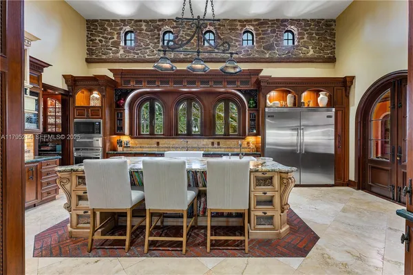 a living room with furniture a fireplace and a chandelier