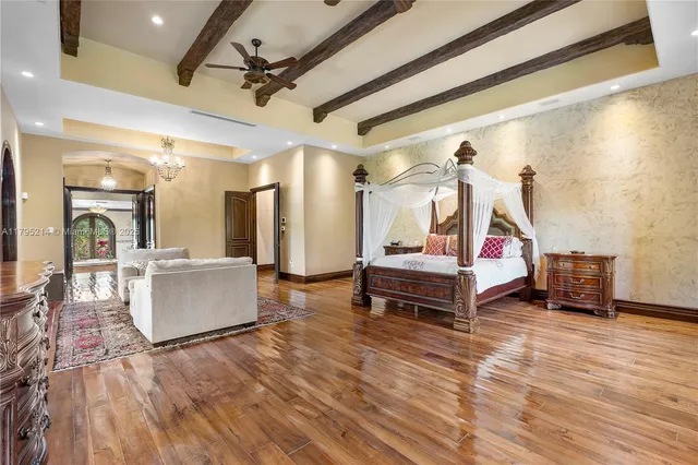 a bedroom with furniture and a wooden floor