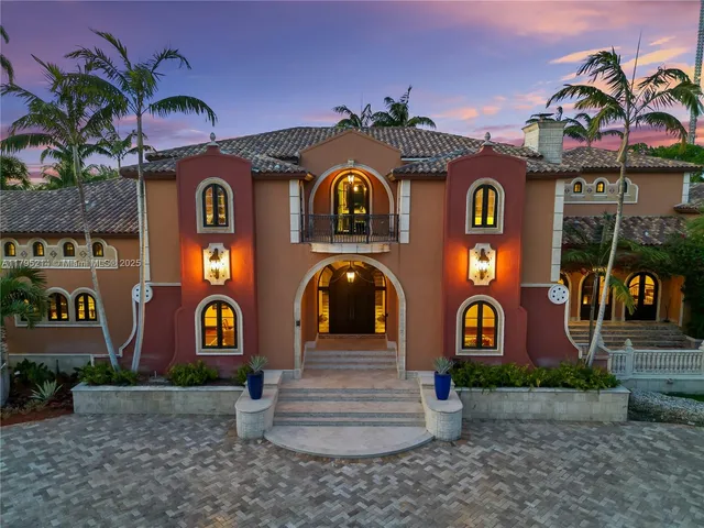 an aerial view of residential house with outdoor space and trees all around