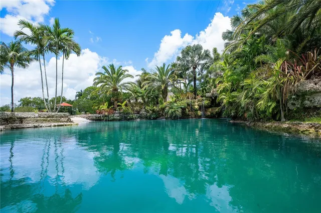 an aerial view of a house with garden space and street view