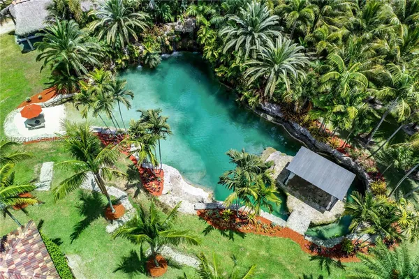 an aerial view of residential house with outdoor space and trees all around