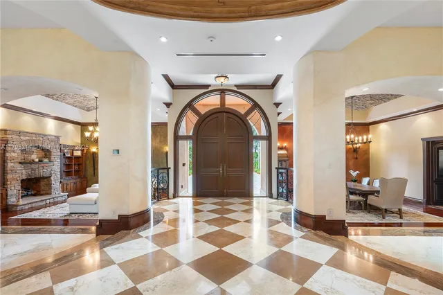 a view of a dining room with furniture and chandelier