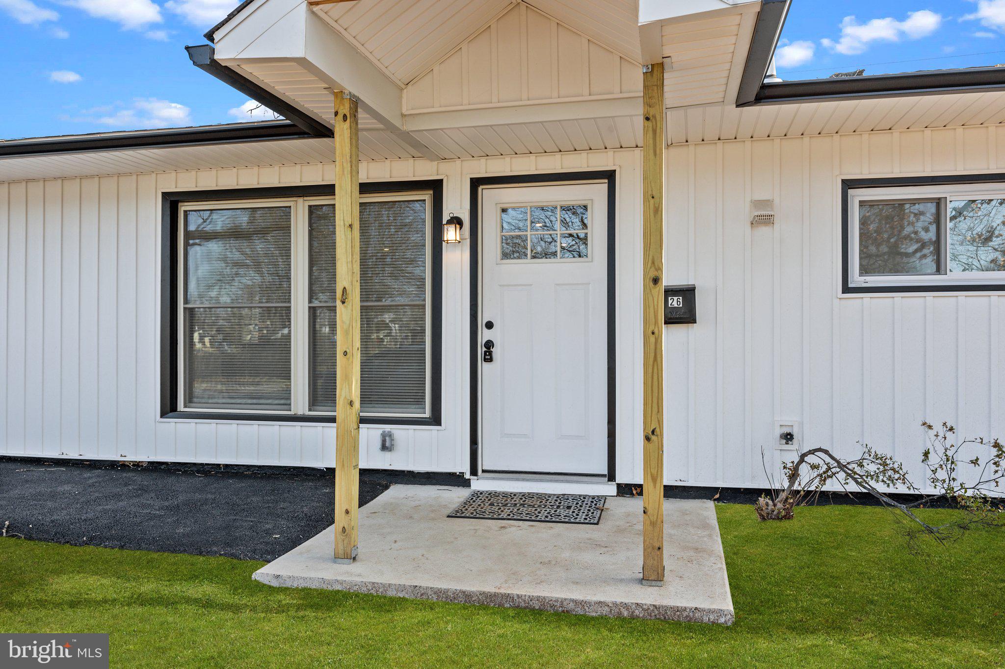 26 Oaktree Drive Levittown, PA 19055 - Photo 4 of 19 a view of front door of house with yard