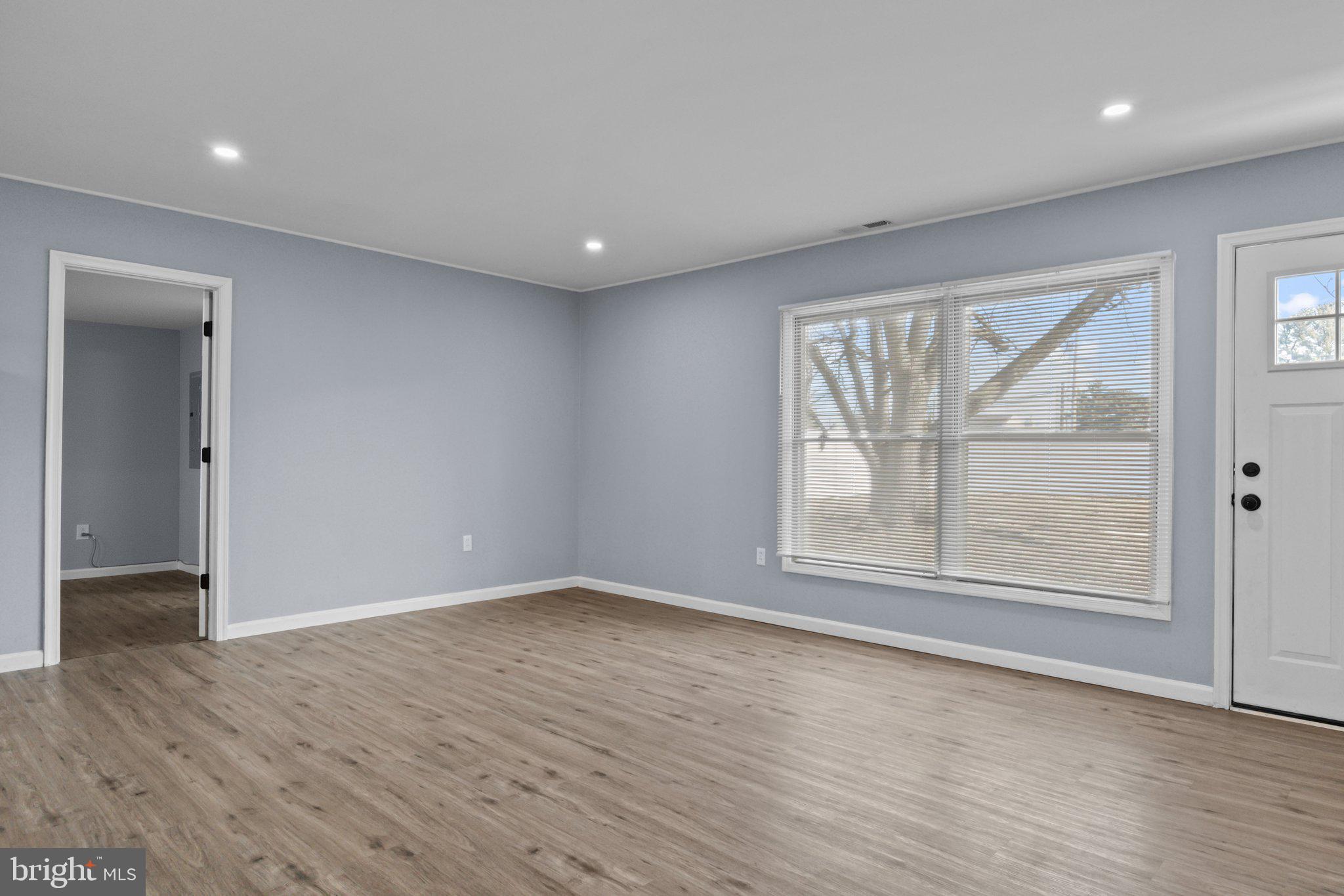 26 Oaktree Drive Levittown, PA 19055 - Photo 6 of 19 an empty room with wooden floor and windows