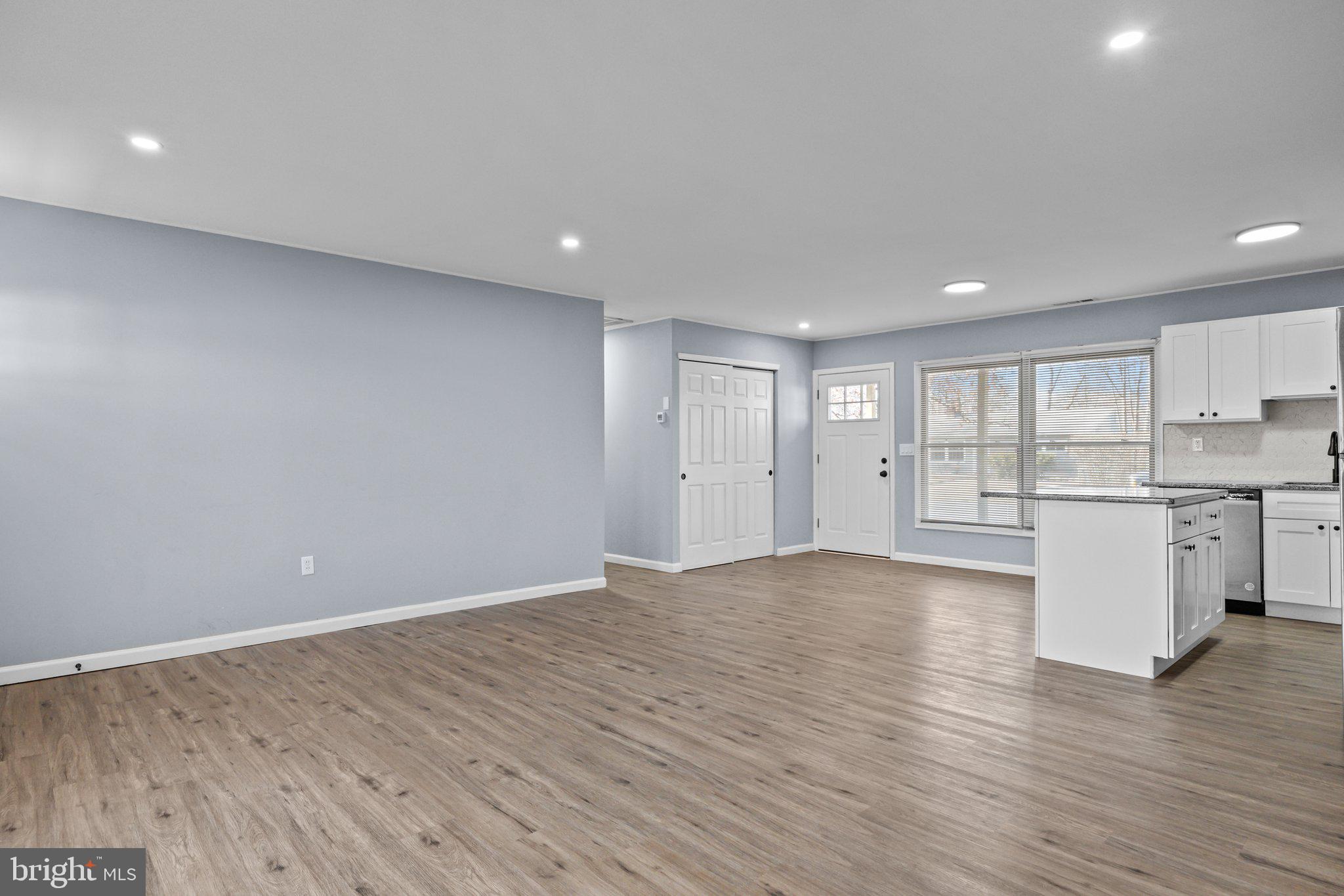 26 Oaktree Drive Levittown, PA 19055 - Photo 7 of 19 a view of an empty room with wooden floor and a window