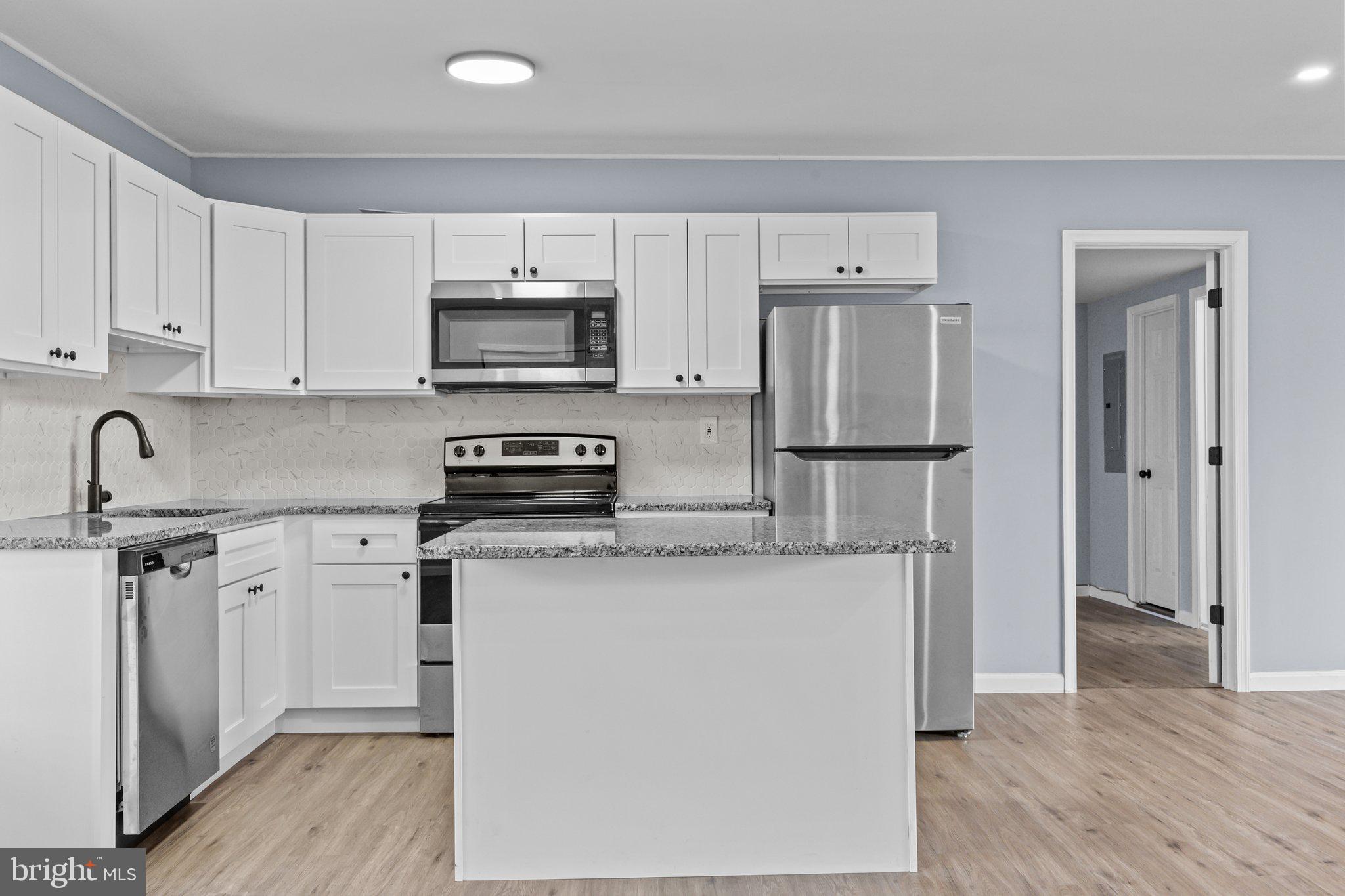 26 Oaktree Drive Levittown, PA 19055 - Photo 9 of 19 a kitchen with stainless steel appliances granite countertop a refrigerator sink and stove