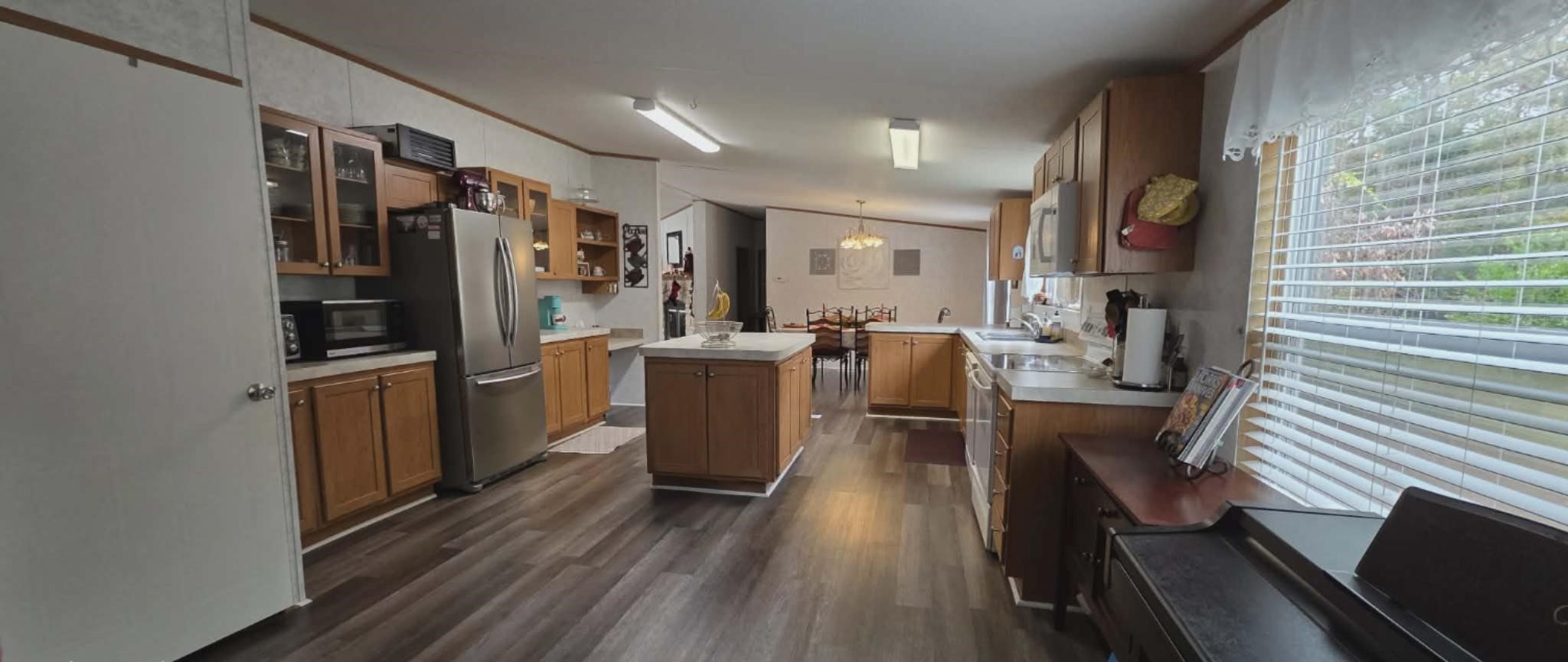 14606 Edwards Road Montgomery, TX 77316 - Photo 11 of 19 a view of a kitchen with fridge and wooden floor