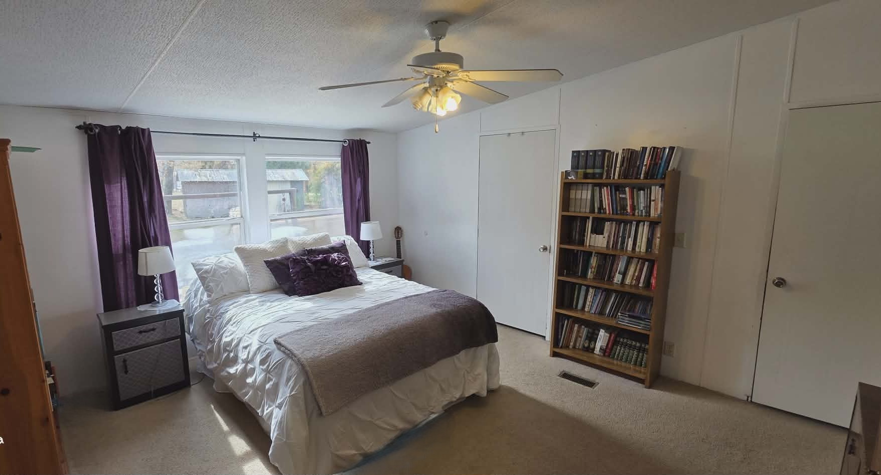 14606 Edwards Road Montgomery, TX 77316 - Photo 12 of 19 a bedroom with a bed a chandelier and a book shelf