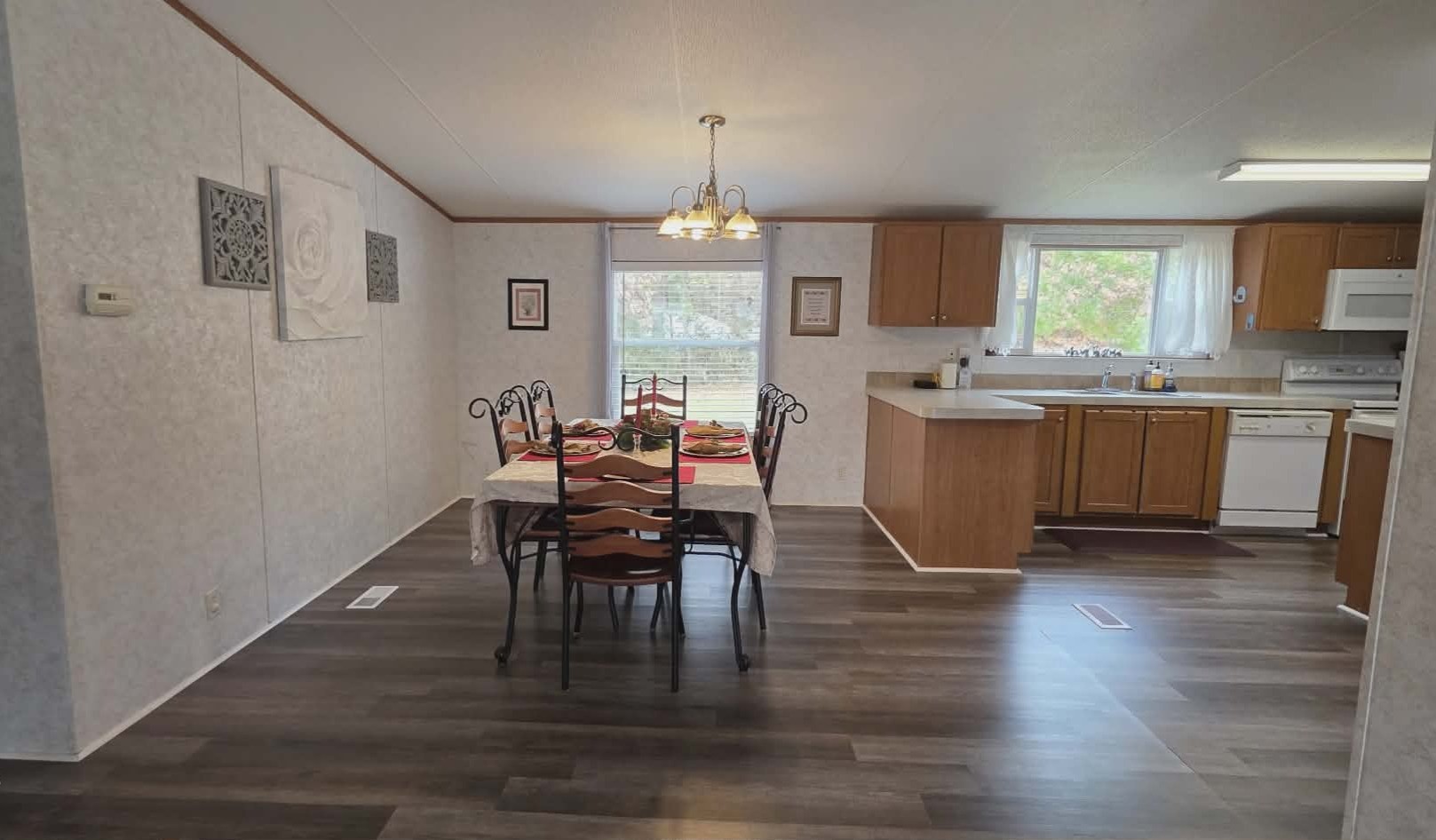 14606 Edwards Road Montgomery, TX 77316 - Photo 6 of 19 a dining room with wooden floor a chandelier a wooden table and chairs