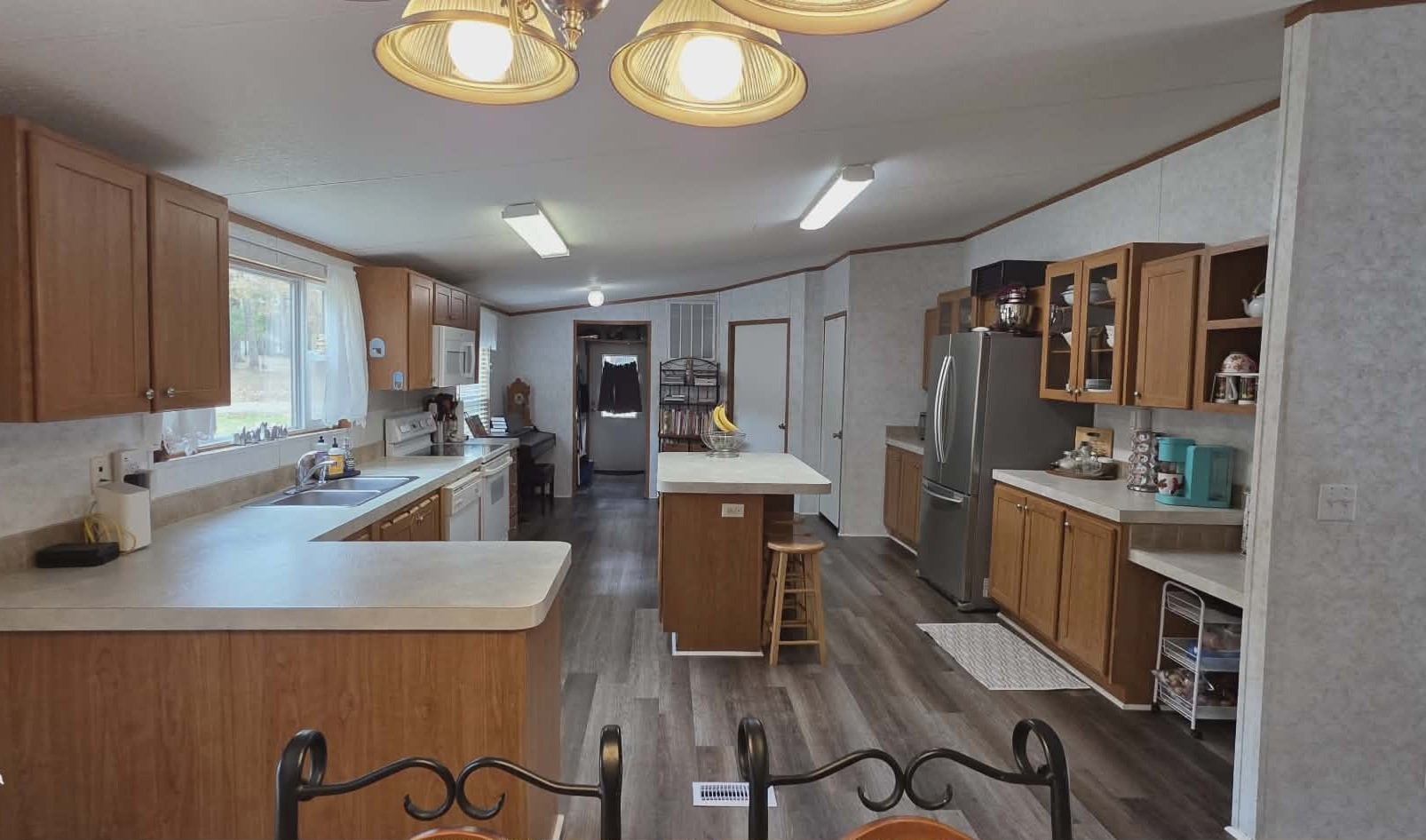 14606 Edwards Road Montgomery, TX 77316 - Photo 10 of 19 a kitchen with sink refrigerator dining table and chairs
