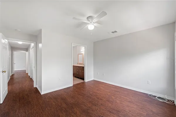 a view of a livingroom with a ceiling fan and wooden floor