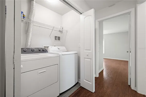 a view of washer and dryer with wooden floor