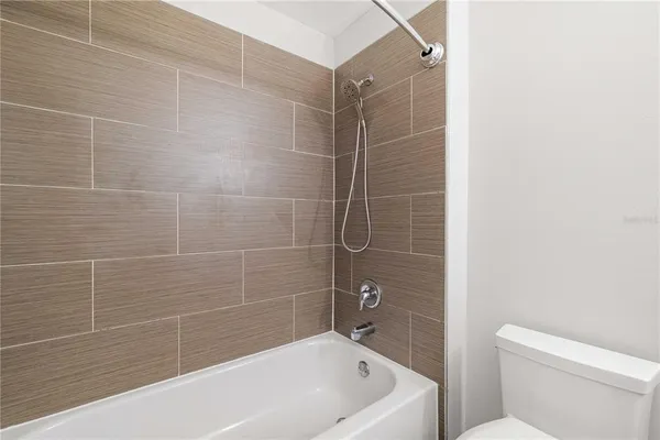 a bathroom with a bathtub and toilet