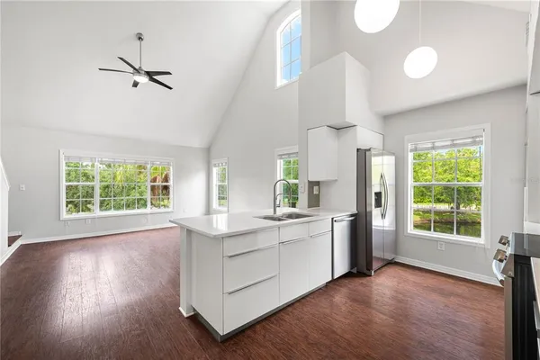 a kitchen with stainless steel appliances granite countertop a stove cabinets and wooden floor