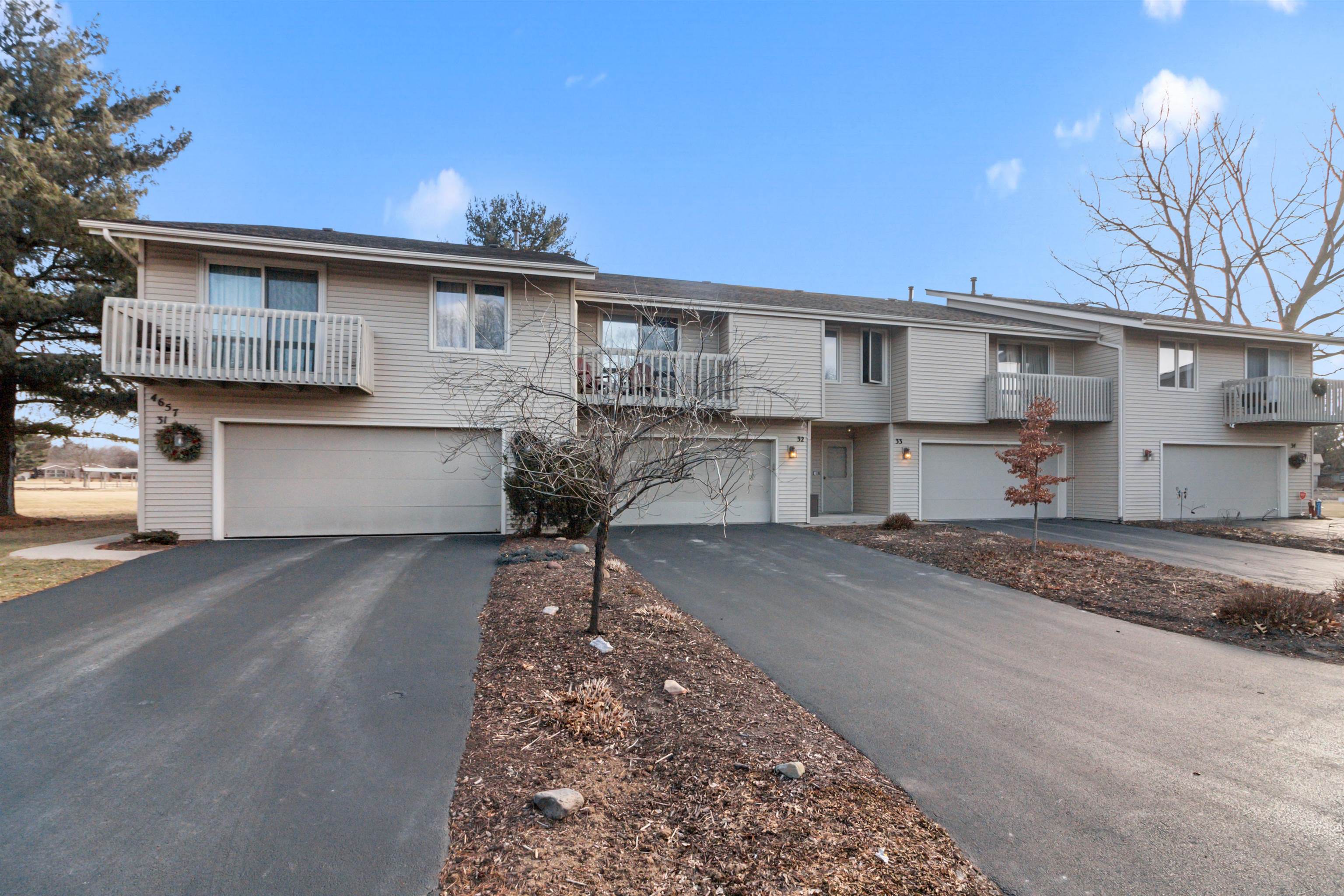 4657 High Point Drive, Unit 32 Rockford, IL 61114 - Photo 1 of 27 a front view of a house with a yard and garage