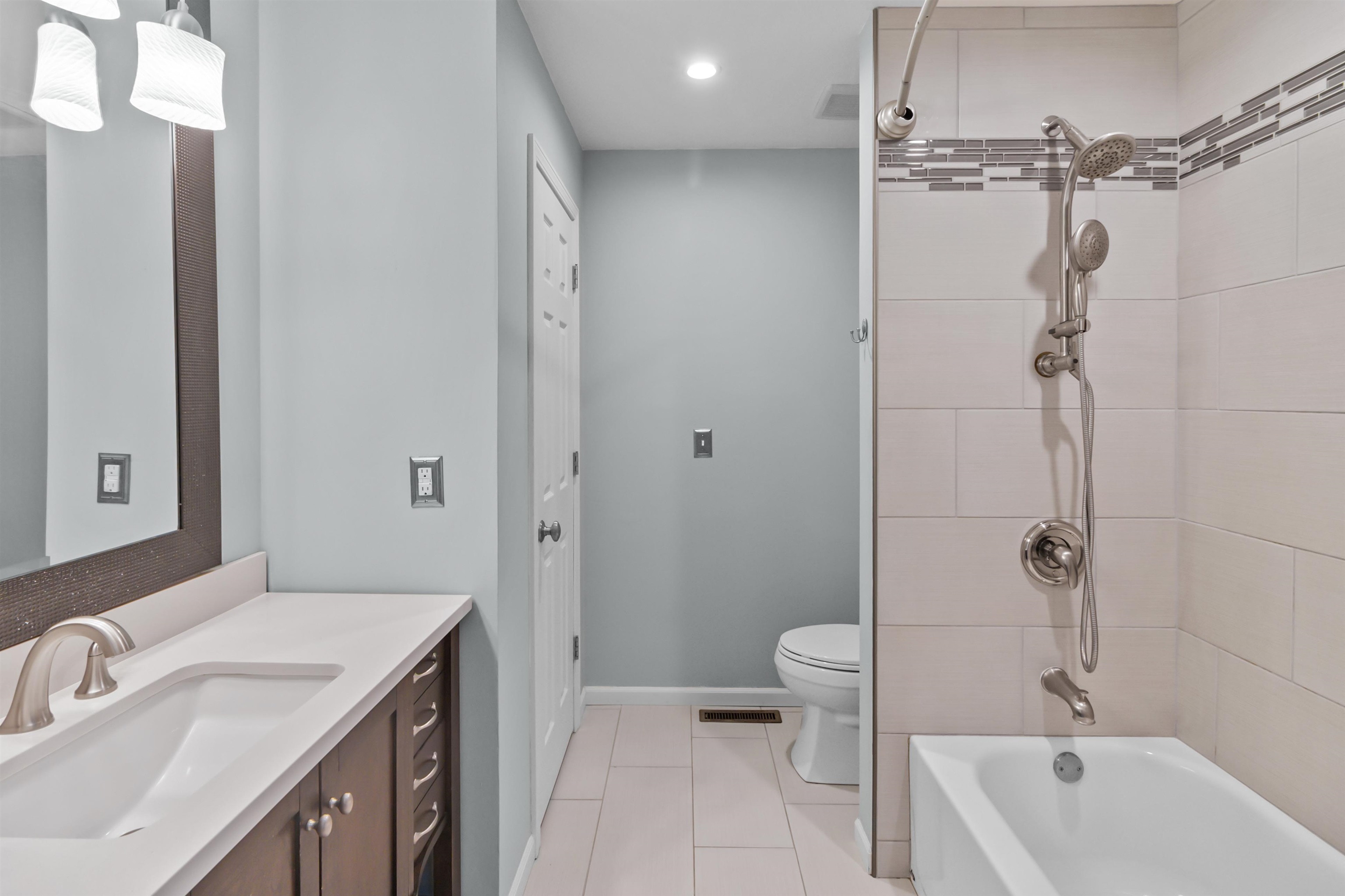 4657 High Point Drive, Unit 32 Rockford, IL 61114 - Photo 17 of 27 a bathroom with a sink a toilet and shower