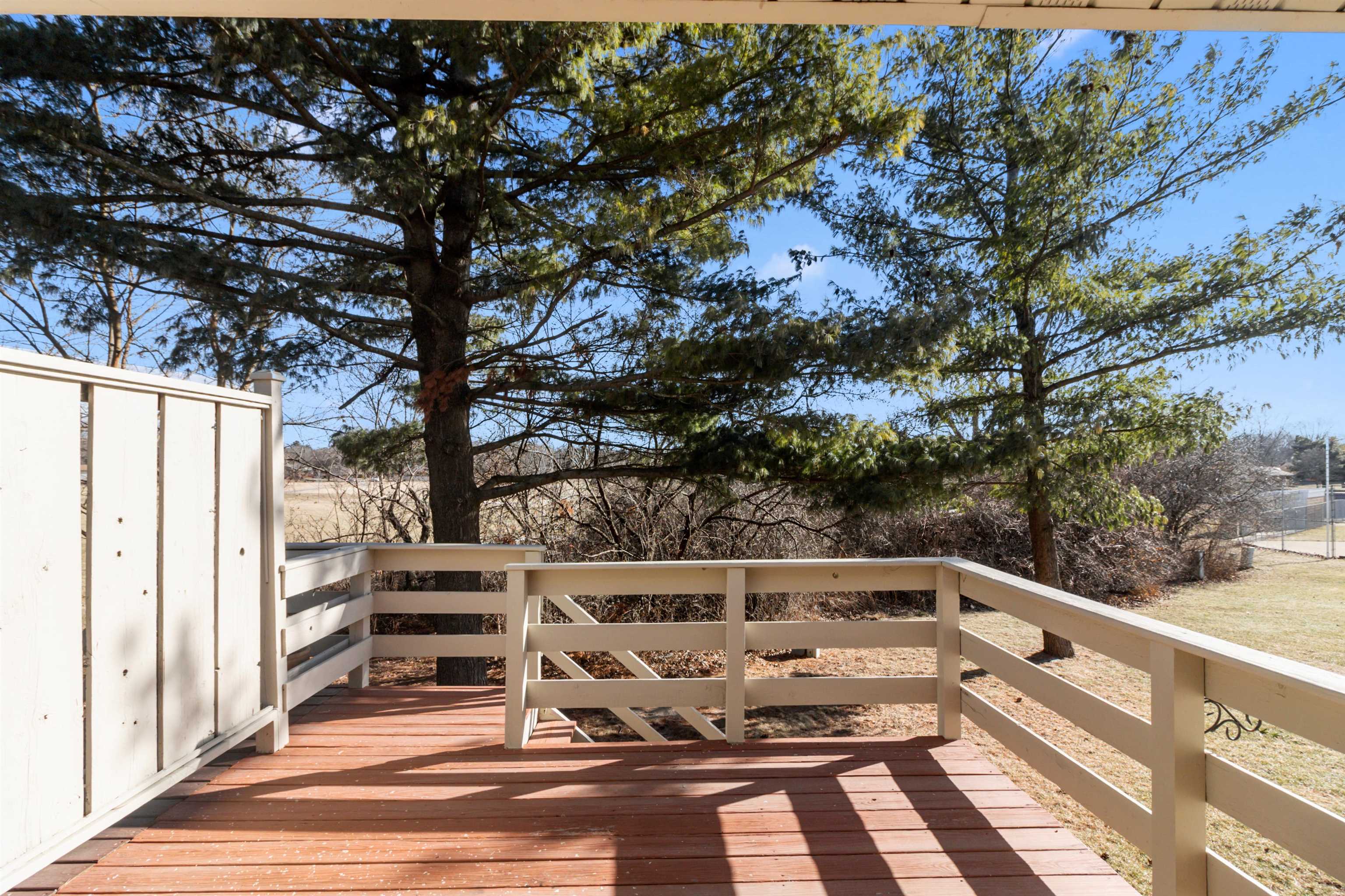 4657 High Point Drive, Unit 32 Rockford, IL 61114 - Photo 22 of 27 a view of deck with chairs and wooden fence