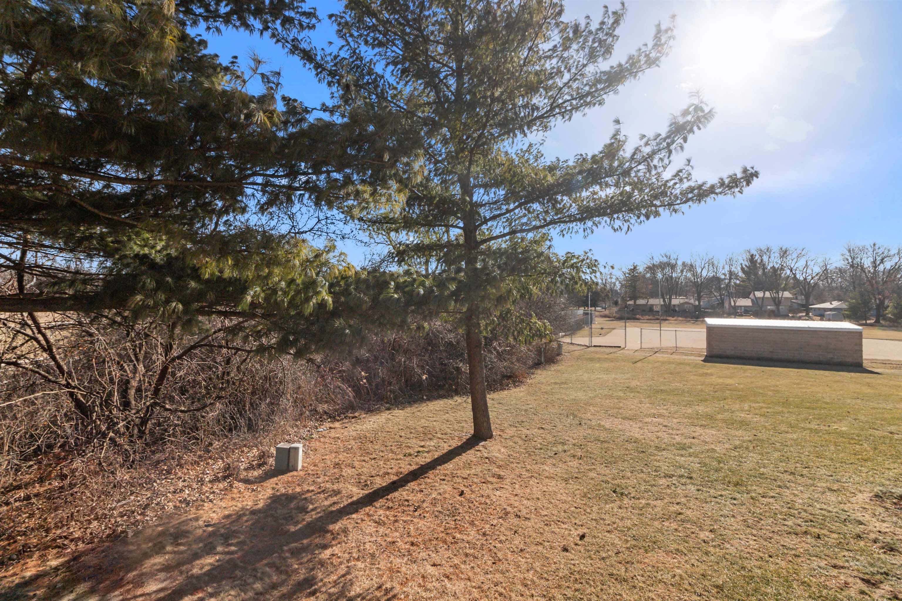 4657 High Point Drive, Unit 32 Rockford, IL 61114 - Photo 24 of 27 a street view with large trees