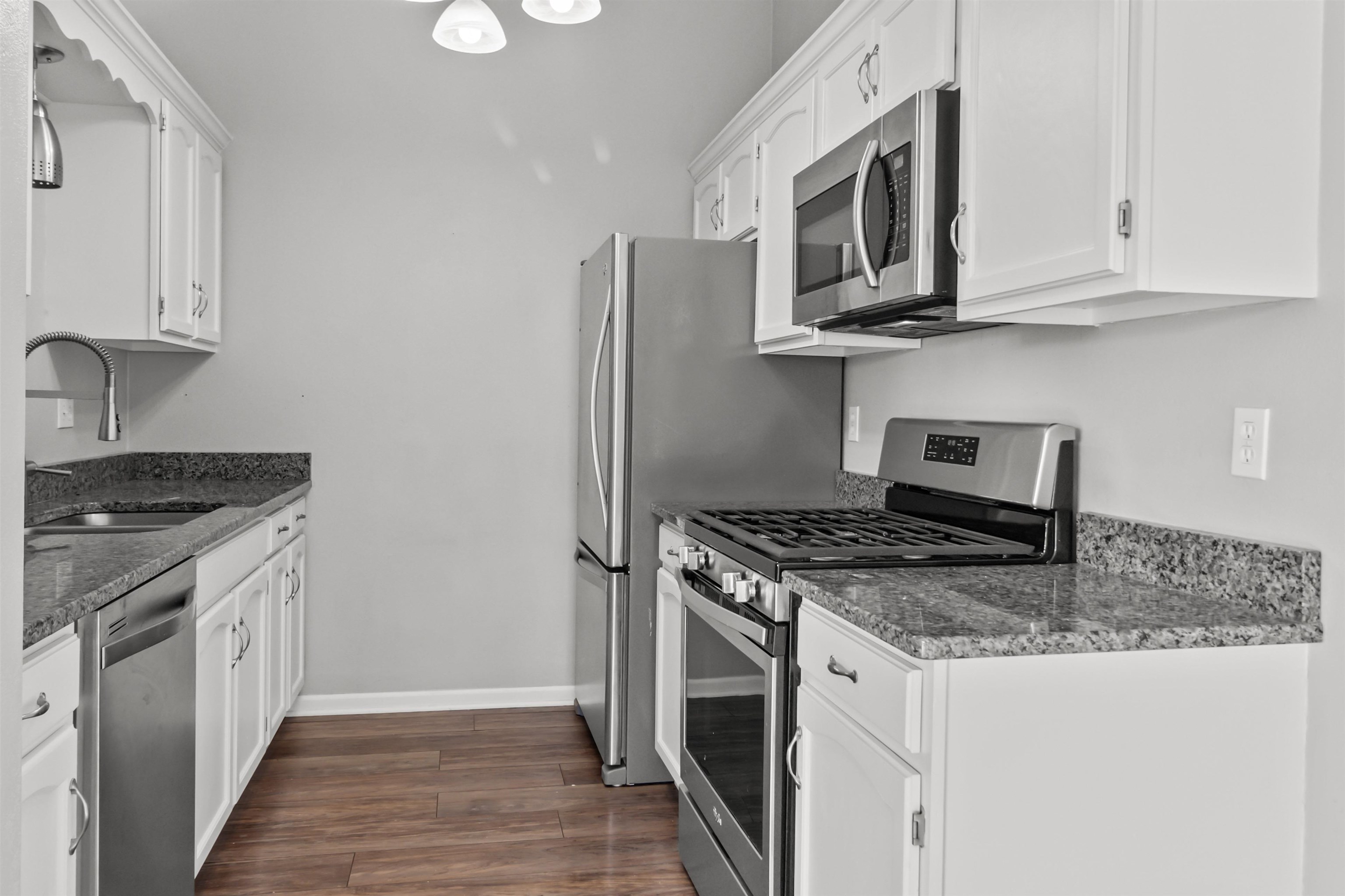 4657 High Point Drive, Unit 32 Rockford, IL 61114 - Photo 10 of 27 a kitchen with stainless steel appliances granite countertop a stove microwave and sink