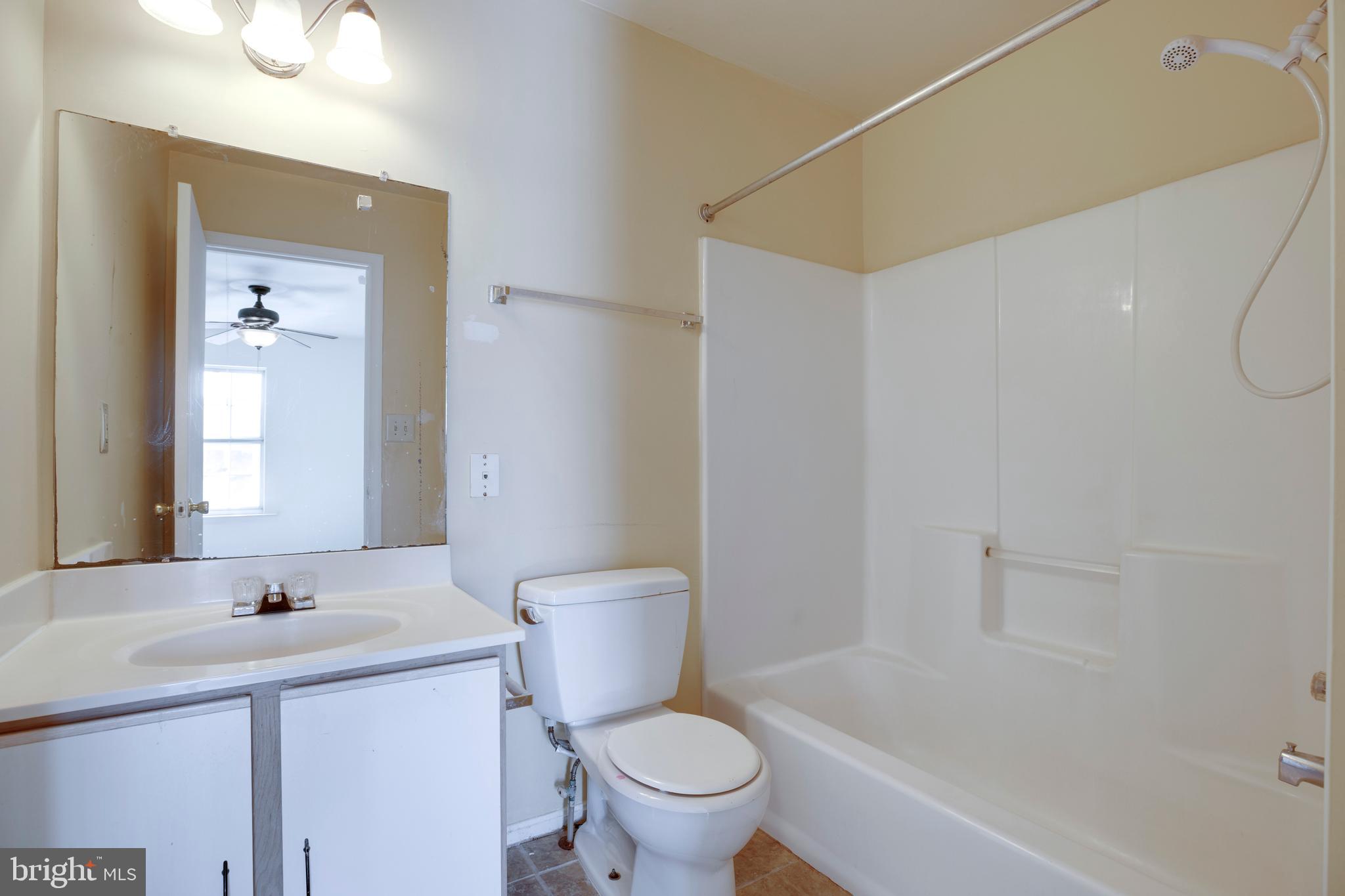 40 Smokewood Court, Unit 40200 Stafford, VA 22554 - Photo 14 of 26 a bathroom with a sink a toilet and a mirror