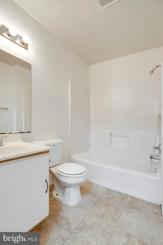a bathroom with a toilet a sink and bathtub