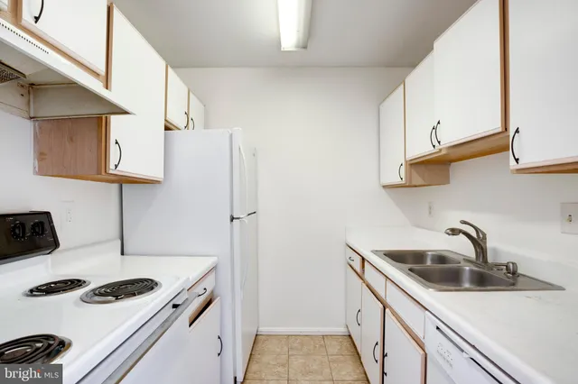 a kitchen with sink a stove and refrigerator