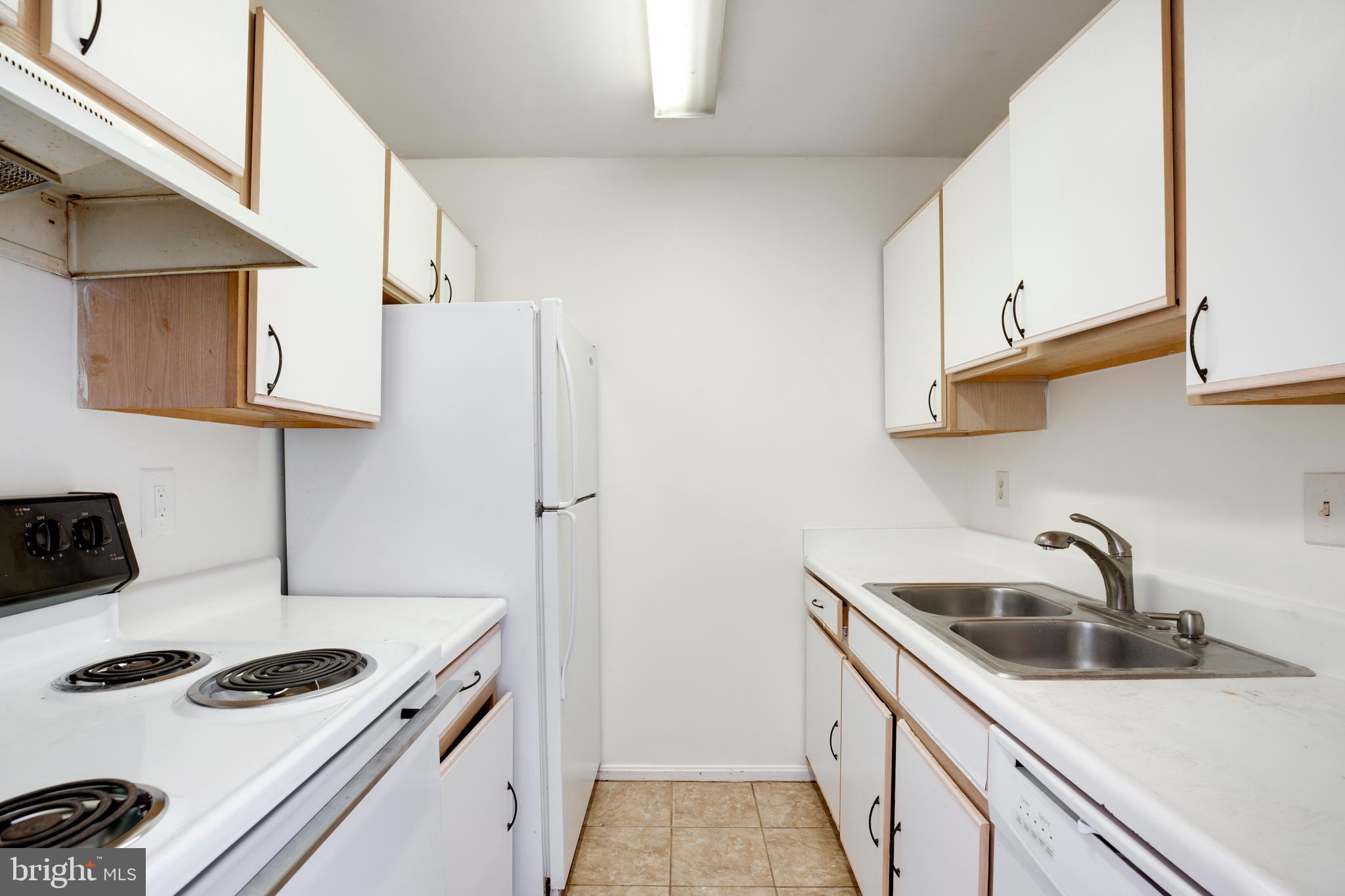 40 Smokewood Court, Unit 40200 Stafford, VA 22554 - Photo 7 of 26 a kitchen with sink a stove and refrigerator