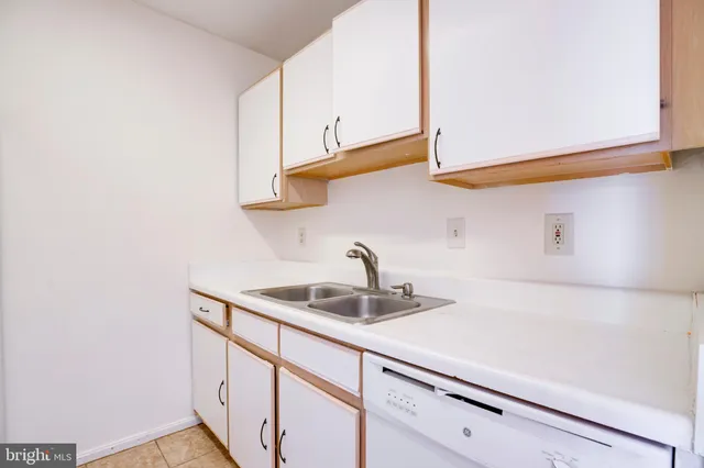 a kitchen with stainless steel appliances a sink and cabinets