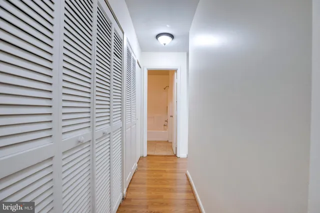 a view of a hallway with wooden floor