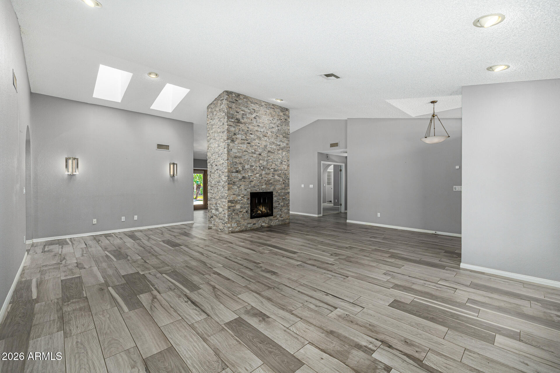 801 East Acoma Drive Phoenix, AZ 85022 - Photo 12 of 62 a view of empty room with wooden floor and fireplace