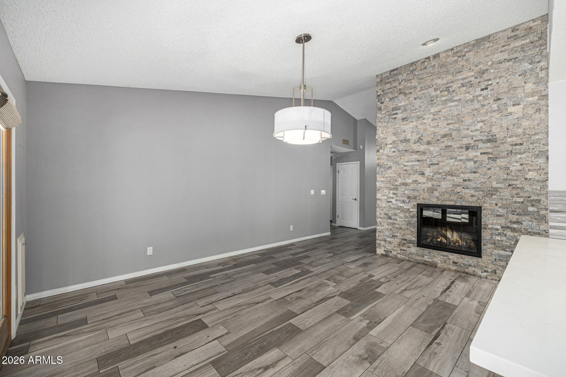 801 East Acoma Drive Phoenix, AZ 85022 - Photo 18 of 62 a view of a livingroom with wooden floor a fireplace and window