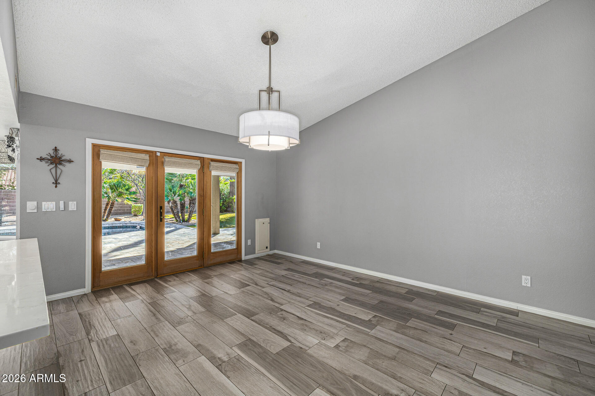 801 East Acoma Drive Phoenix, AZ 85022 - Photo 20 of 62 a view of an empty room with wooden floor and a window
