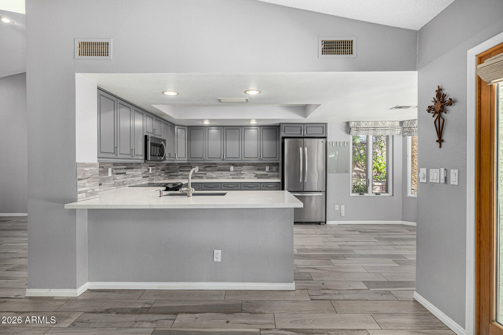 801 East Acoma Drive Phoenix, AZ 85022 - Photo 21 of 62 a large kitchen with stainless steel appliances kitchen island a large counter top and a refrigerator