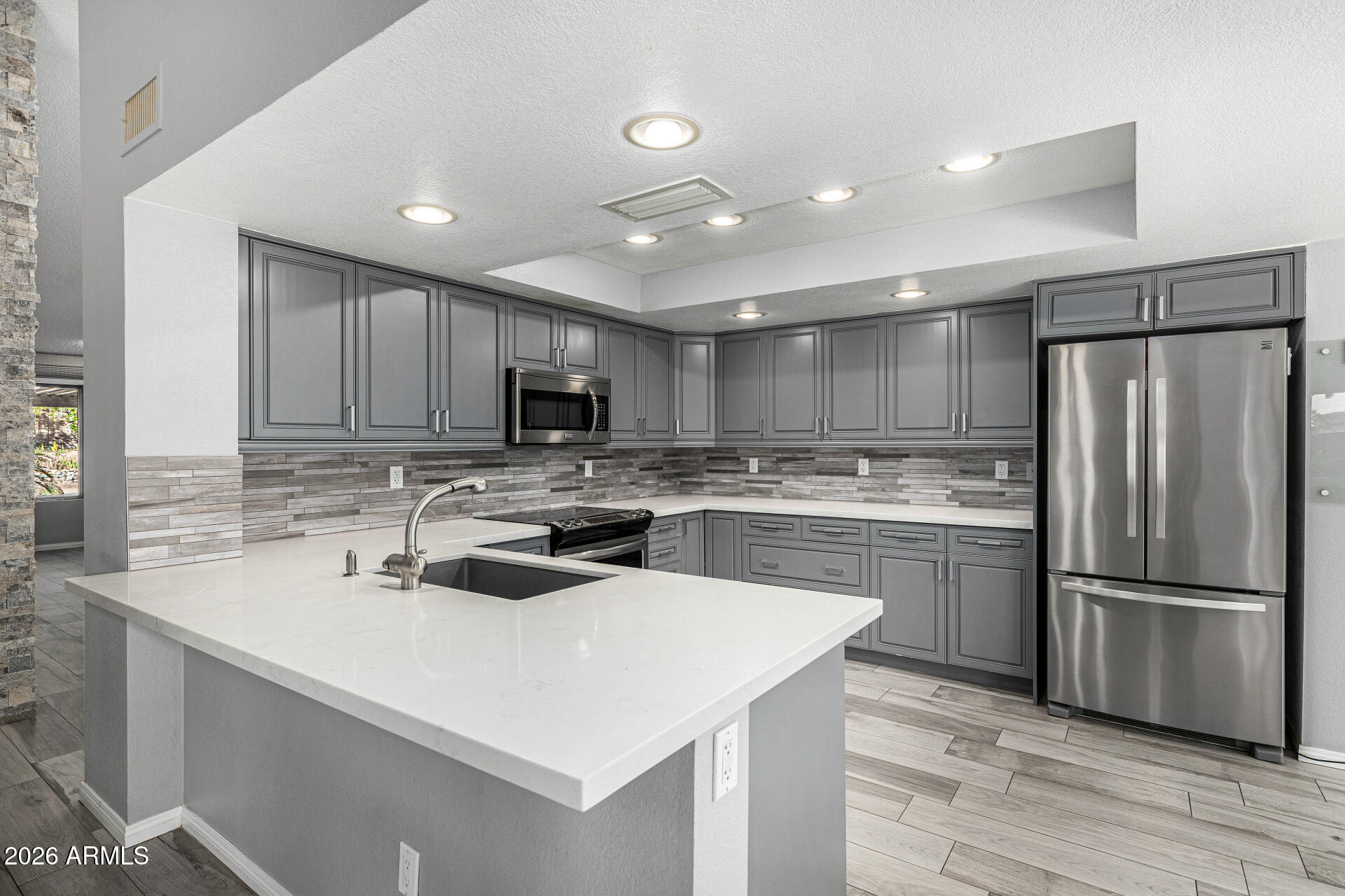 801 East Acoma Drive Phoenix, AZ 85022 - Photo 23 of 62 a kitchen with a sink a refrigerator a microwave and cabinets