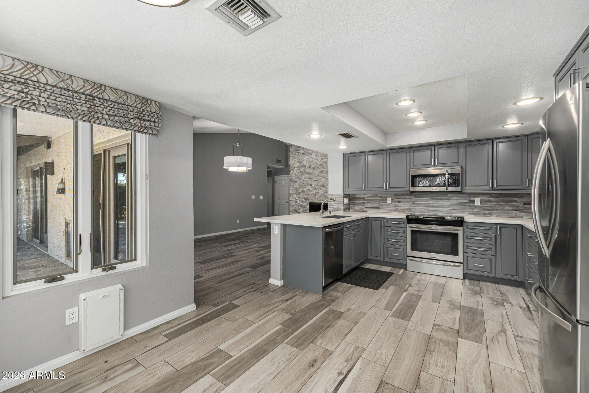 801 East Acoma Drive Phoenix, AZ 85022 - Photo 29 of 62 a large kitchen with a stove top oven and refrigerator