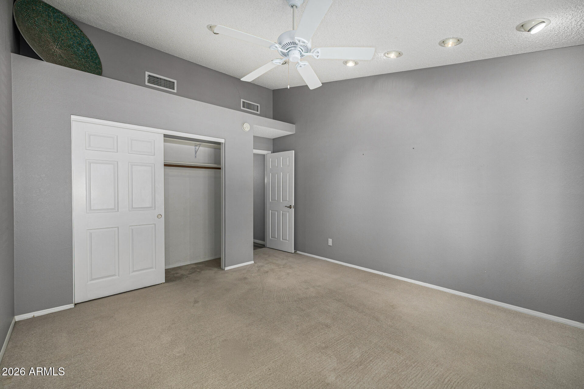 801 East Acoma Drive Phoenix, AZ 85022 - Photo 43 of 62 an empty room with a ceiling fan and carpet