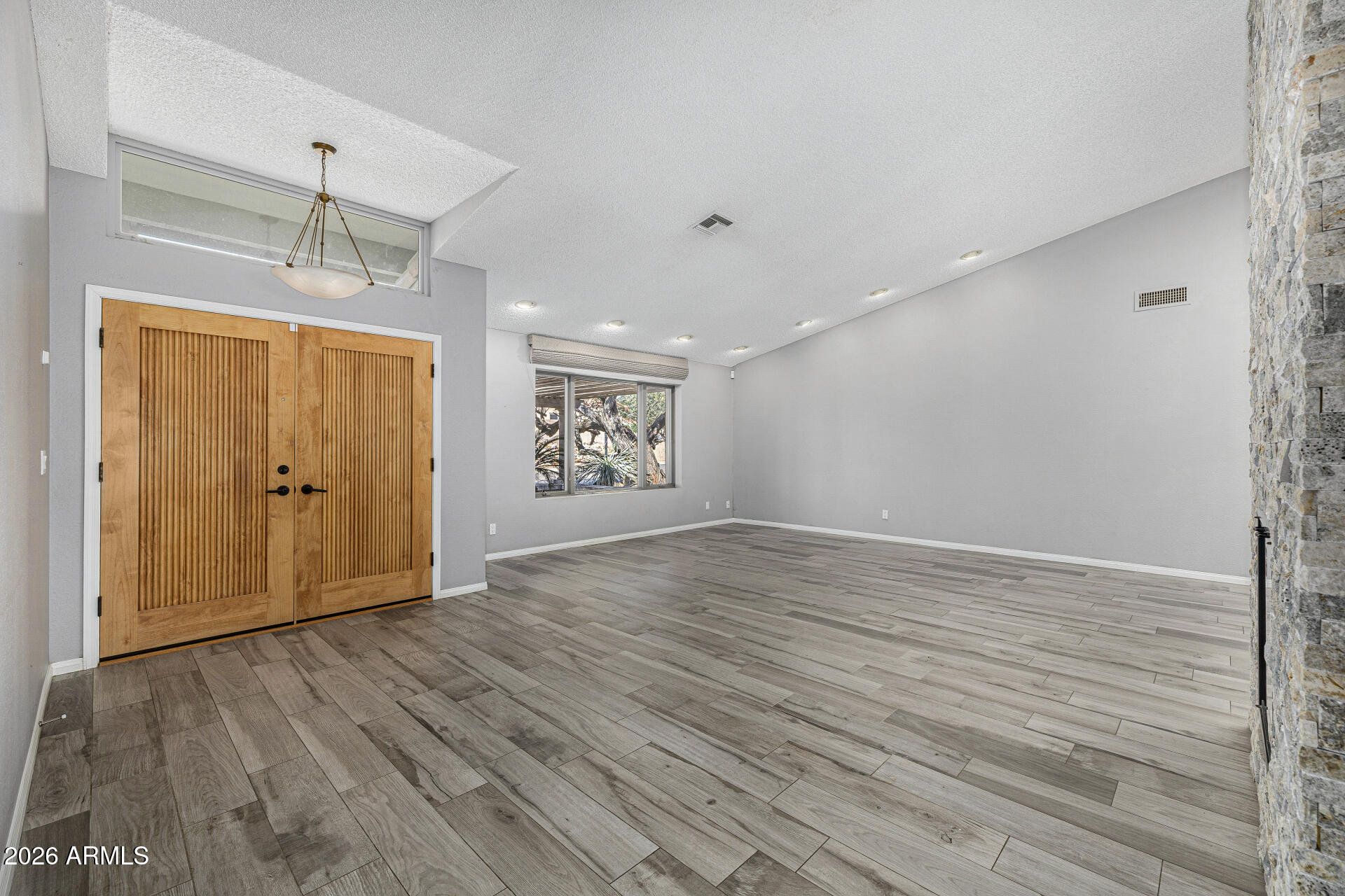 801 East Acoma Drive Phoenix, AZ 85022 - Photo 8 of 62 a view of an empty room with wooden floor and a window