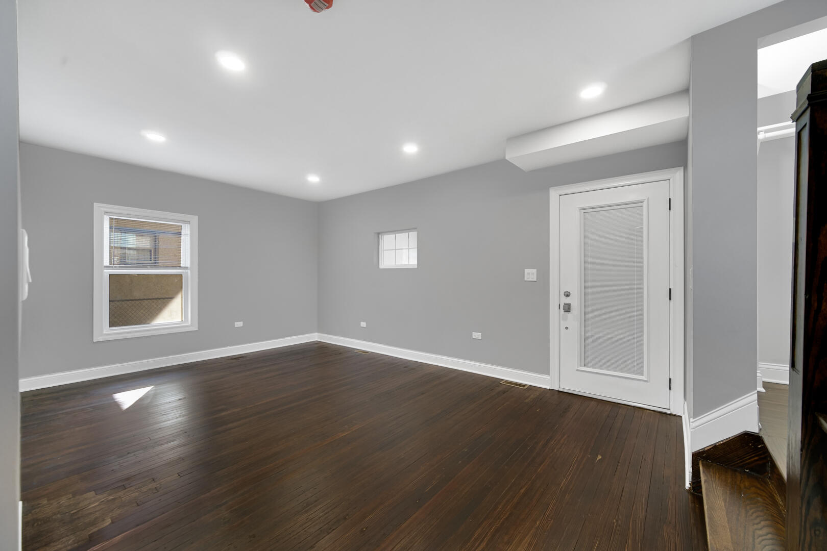 327 Buchanan Street Gary, IN 46402 - Photo 13 of 30 a view of an empty room with wooden floor and a window