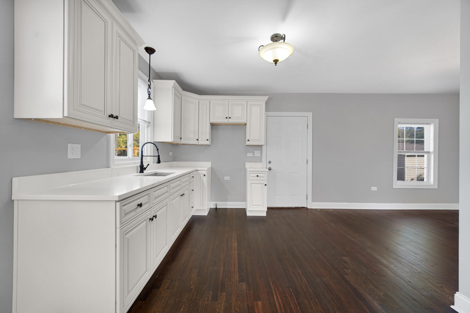 327 Buchanan Street Gary, IN 46402 - Photo 13 of 29 a kitchen with cabinets wooden floor and a sink