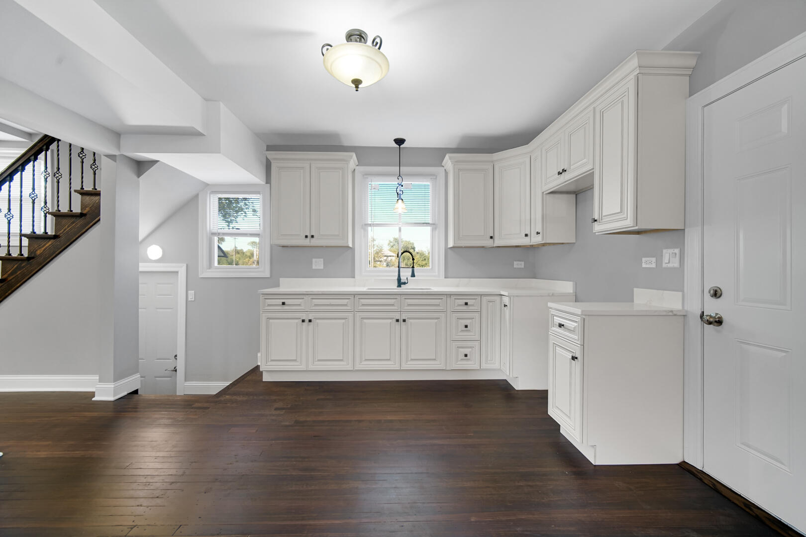 327 Buchanan Street Gary, IN 46402 - Photo 15 of 29 a kitchen with stainless steel appliances white cabinets and wooden floors
