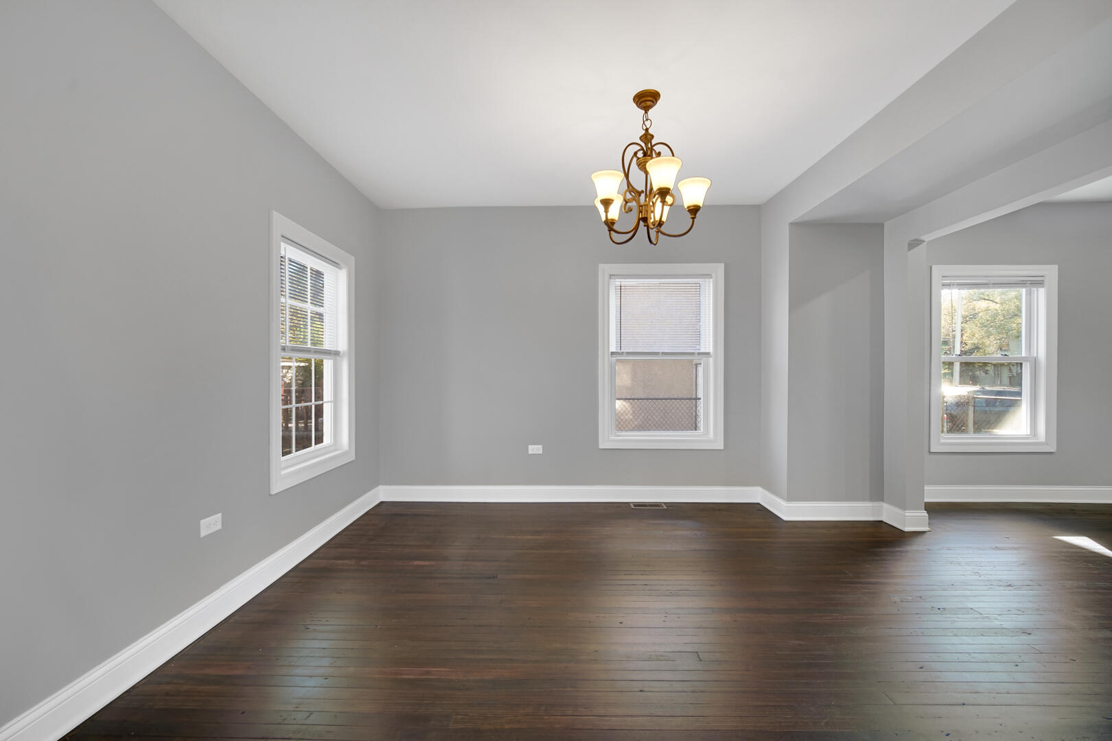 327 Buchanan Street Gary, IN 46402 - Photo 16 of 30 a view of an empty room with wooden floor and windows