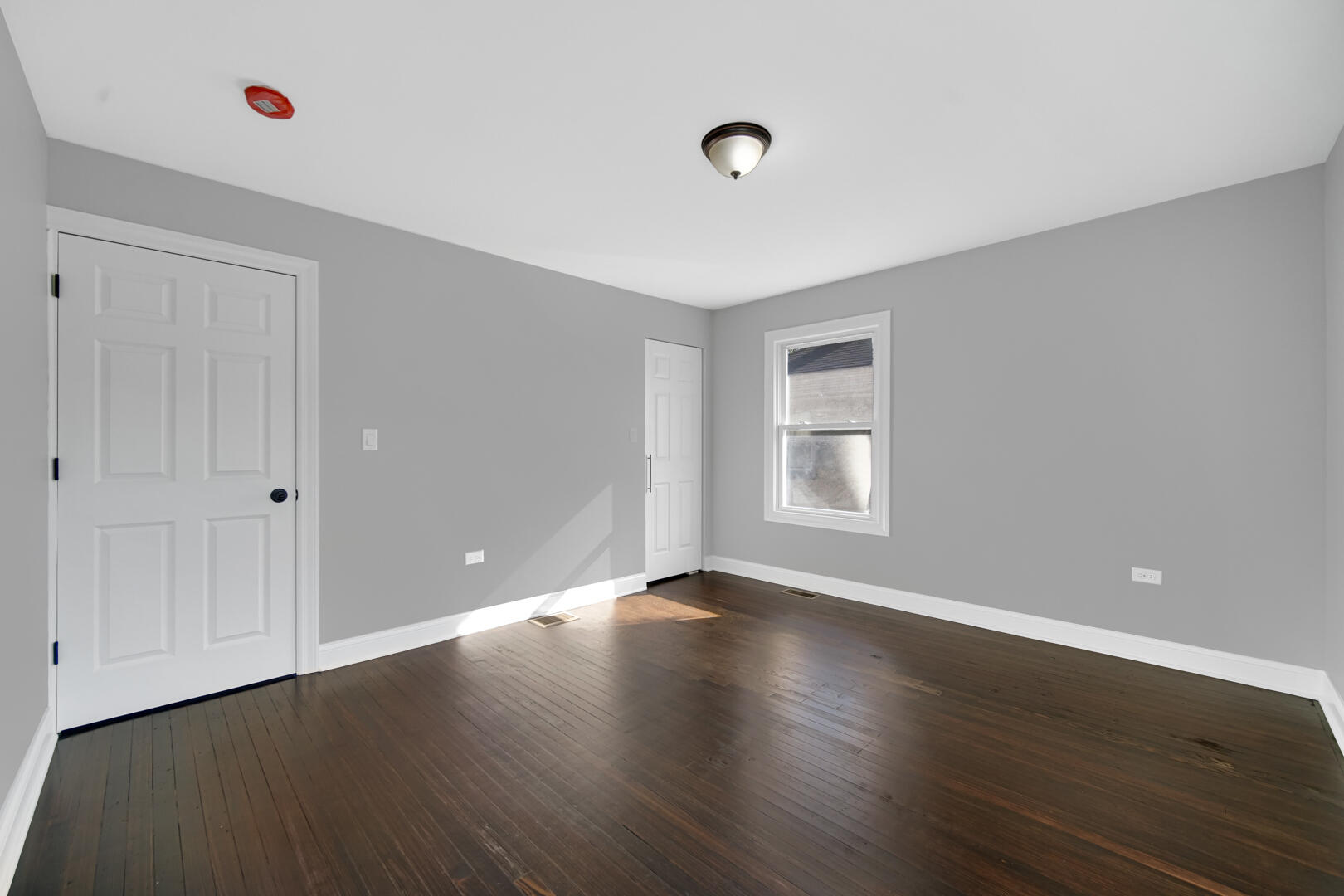 327 Buchanan Street Gary, IN 46402 - Photo 22 of 30 a view of an empty room with wooden floor and a window