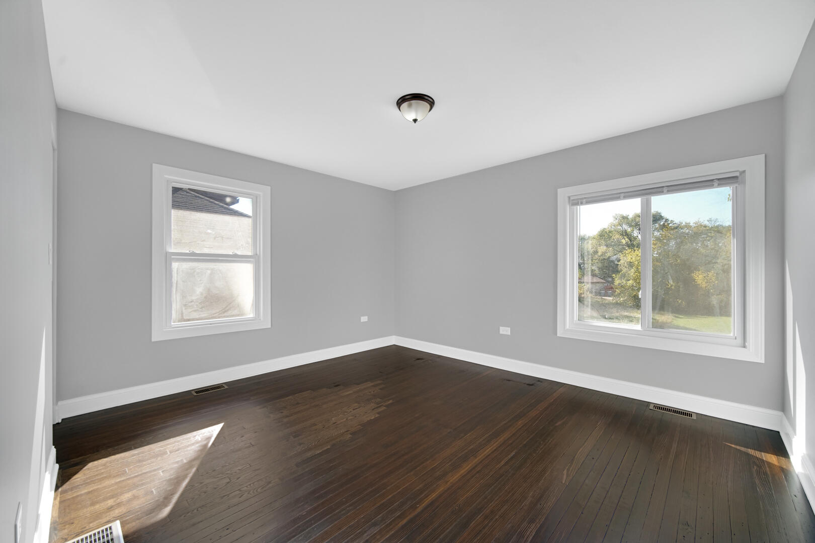 327 Buchanan Street Gary, IN 46402 - Photo 23 of 30 a view of an empty room with wooden floor and a window