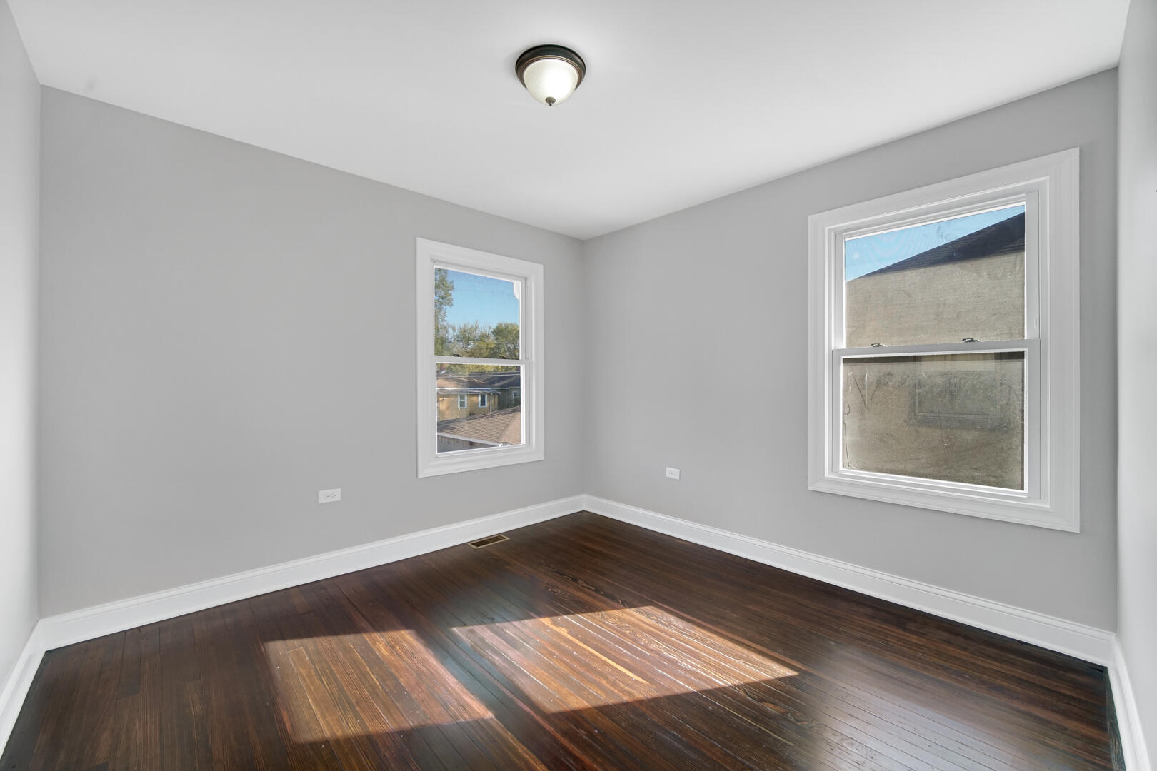 327 Buchanan Street Gary, IN 46402 - Photo 23 of 29 an empty room with wooden floor and windows