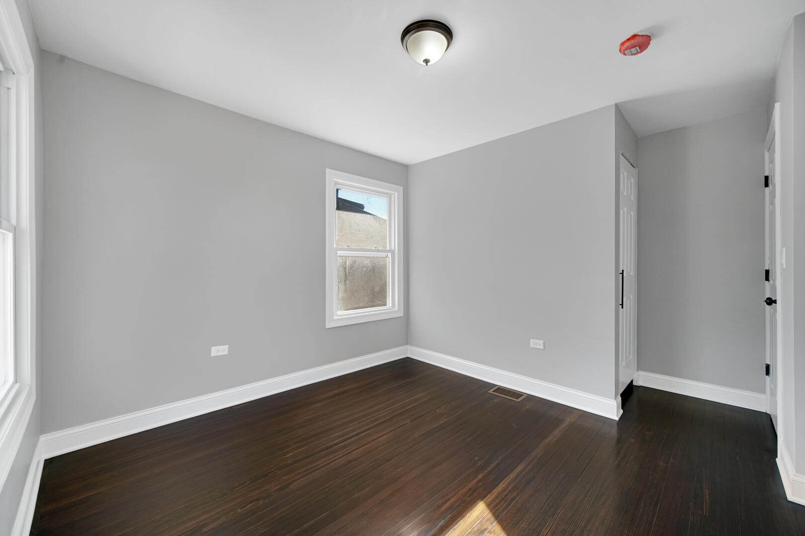 327 Buchanan Street Gary, IN 46402 - Photo 24 of 29 an empty room with wooden floor and windows