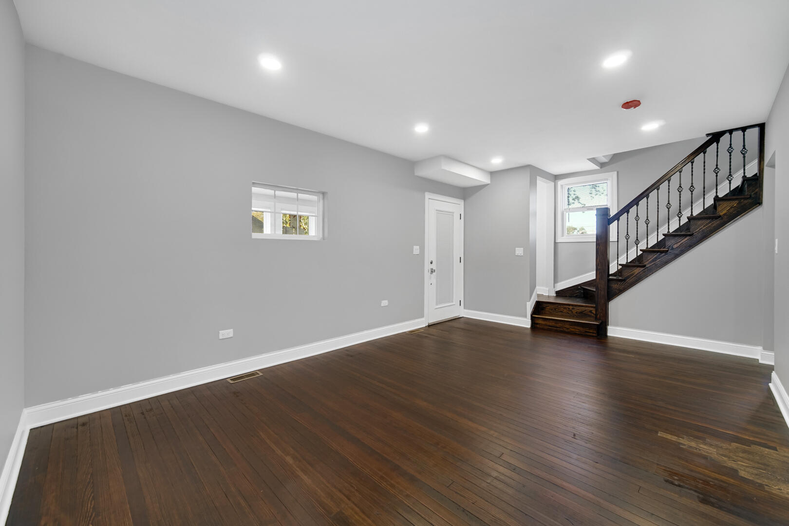 327 Buchanan Street Gary, IN 46402 - Photo 10 of 30 a view of a room with wooden floors and stairs