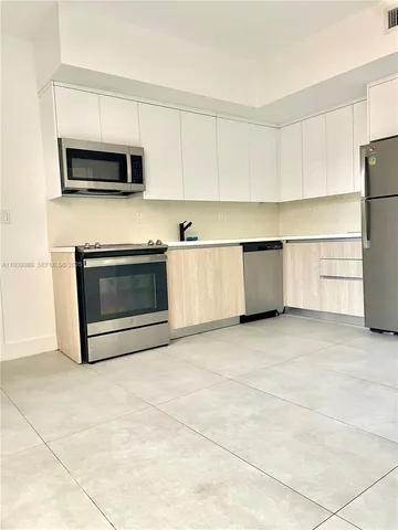 an empty room with windows and entrance