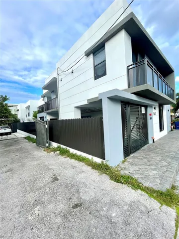 a front view of a house with parking space